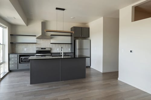Modern kitchen with isle at Riverhouse Apartments in Fargo, ND 58102