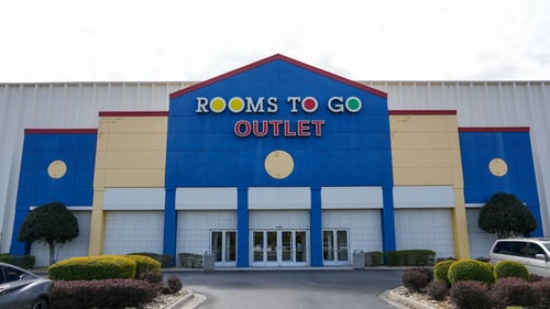 yellow and blue storefront for Rooms To Go Outlet in Norcross, GA