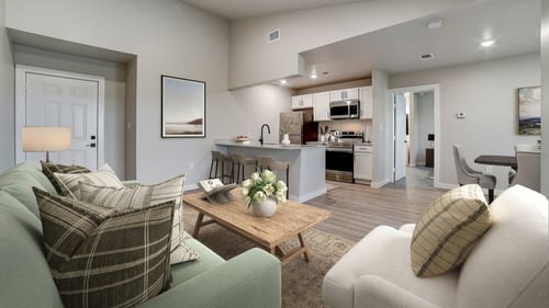 a living room with couches and a coffee table in front of a kitchen at The Frederick, San Antonio