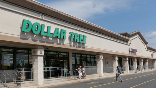 Two people walking of entrance of Dollar Tree at Tinton Falls Plaza shopping center