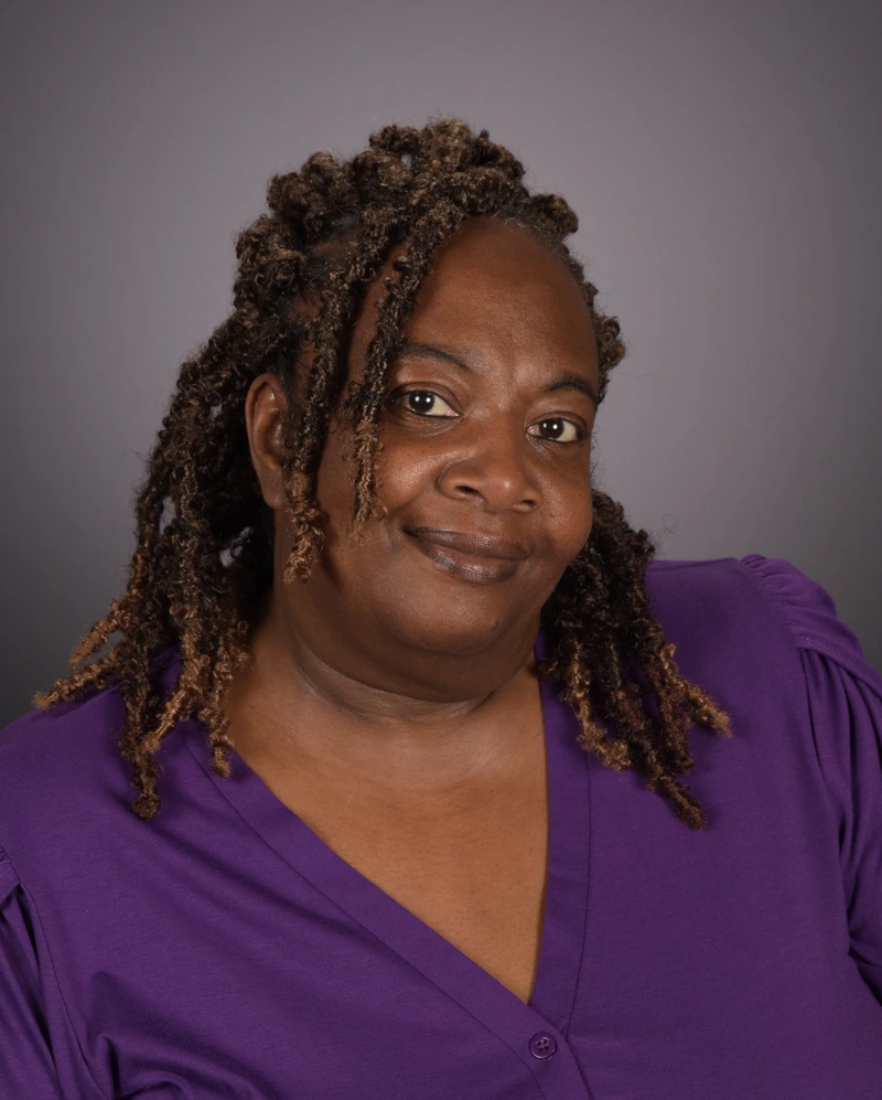 Headshot of School Director Reknottis Allen