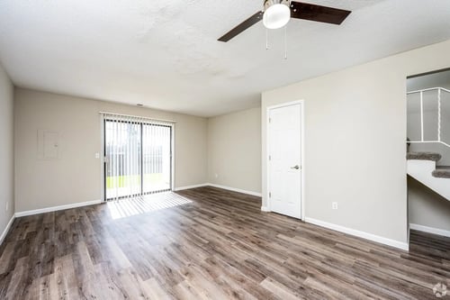 A bedroom with a ceiling fan at Black Hawk Apartments, Indiana