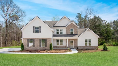 New construction 2-story brick front home with white siding in the DRB Homes Saddleridge community