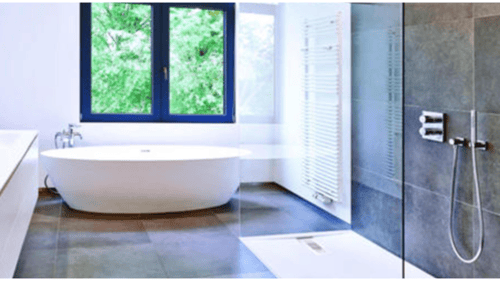 bathroom with glass shower door and bathtub
