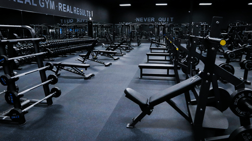 Strength training area at Epic Health & Fitness Windsor Locks, featuring free weights, benches, and barbells for a comprehensive workout experience. Perfect for anyone seeking the best gym near you for weightlifting and functional fitness.