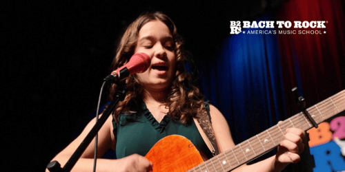 Girl singing on stage at Bach to Rock event