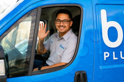 Plumber waving from the bluefrog van.