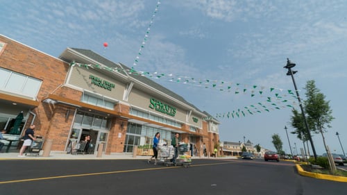 Decorative green an white garland hanging across entrance of Sprouts at Marlton Crossing Shopping Center