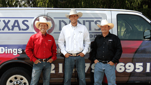 Texas Dent Mobile service van with owners and dent technicians standing in front.