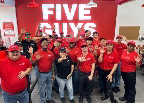 Crew members pose for a photograph inside the dining room ahead of the grand opening of the Five Guys restaurant at 12016 Alamo Ranch Parkway in San Antonio, Texas.