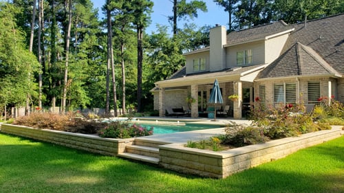 Large house with in ground pool in front of it