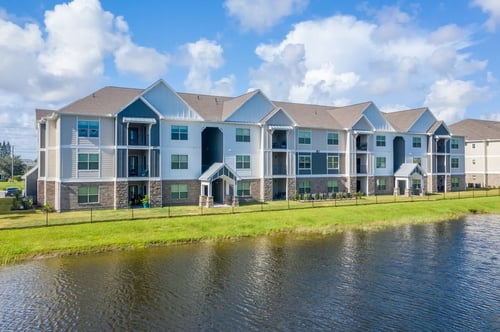 Apartment building with lake view at Mode at Melbourne in Melbourne, FL, 32901