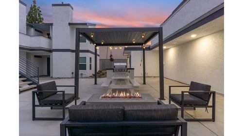 Outdoor patio has a fire pit and seating around it at Hamilton Courtyard Apartments