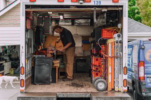 Team member cutting ducts inside the service truck