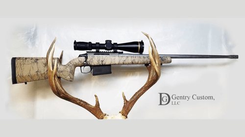 custom rifle between a set of antlers