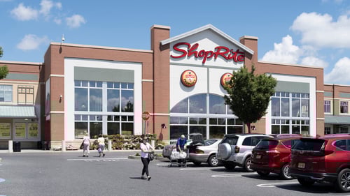 Woman walking past row of parked cars at entrance of Shop Rite at the Shoppes of Cinnaminson shopping center