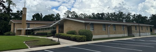 A picture of the outside of The Church of Jesus Christ of Latter-Day Saints Brick City Ward, Forest Ward and Liberty Ward all meet in this building.