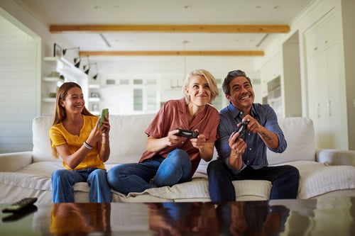 Family on couch enjoying internet from their local internet provider