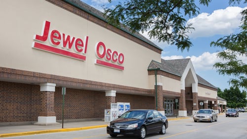 Three cars in a row driving along front of Jewel Osco at The Commons of Crystal Lake shopping center
