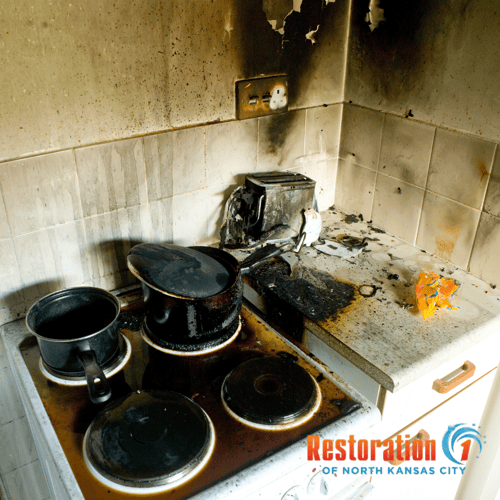 Soot-covered bowls and kitchenware on a countertop after a house fire.