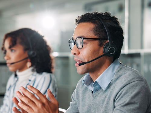 Two call center workers with headsets