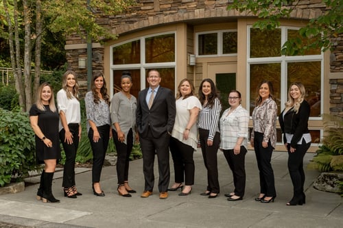 Staff in professional attire smiling