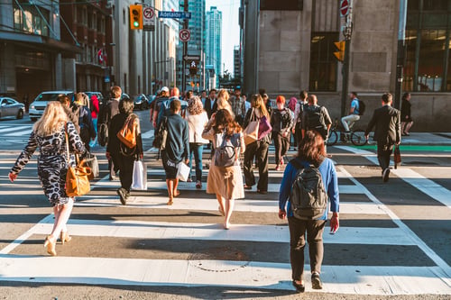people walking across a crosswalk