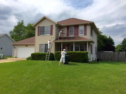 Painters painting a house
