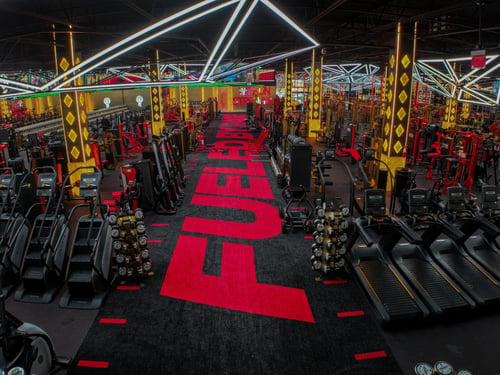 Premium cardio area with treadmills, ellipticals, and modern lighting at our Lombard gym.