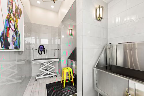 A bathroom with a yellow stool and a sink.