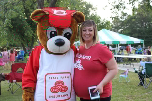 Team member and neighbear standing and smiling together