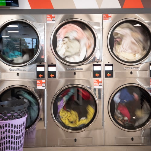 Large-capacity Speed Queen Laundry dryers with clothes inside