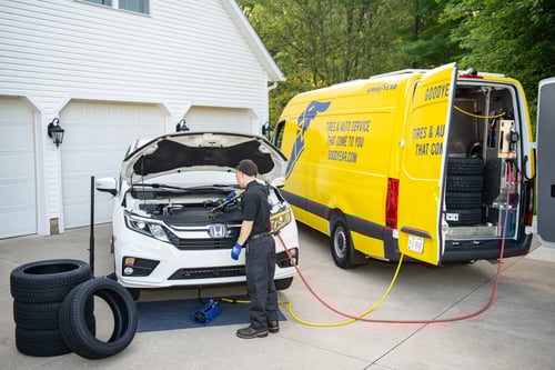 Roll by Goodyear Van Pulling into a Driveway to Perform a Tire Installation.