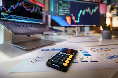 Multi-monitor trading station with live market data and technical analysis charts
