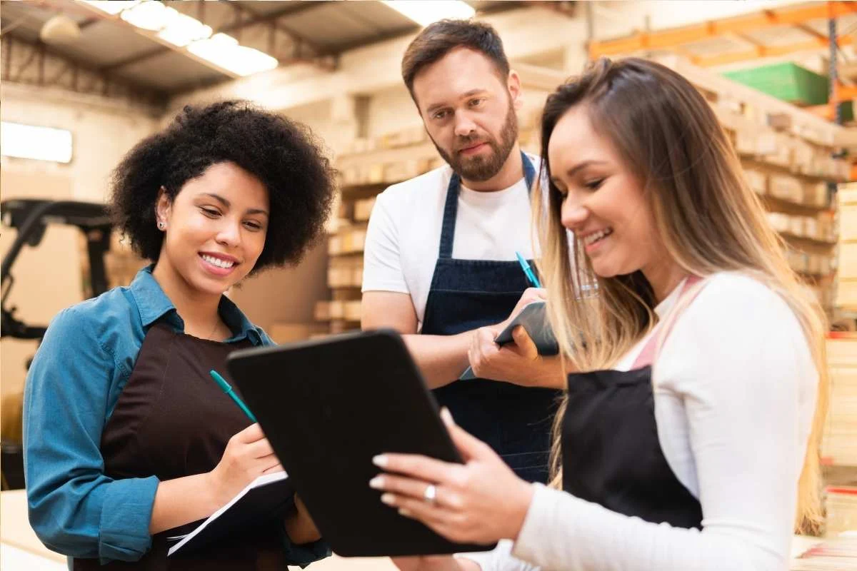 Workers reviewing tasks together while standing on a hard floor