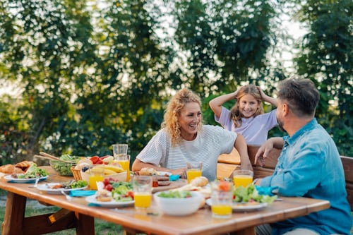 family eating a summer dinner outside