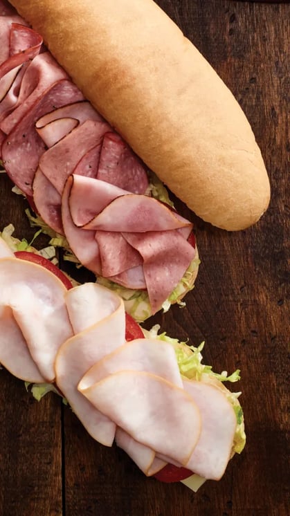 Mr.Sub subs with ham and turkey on white sub rolls.