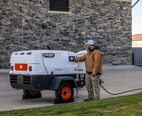 Operator quickly starts his Bobcat pa185 Portable Air Compressor