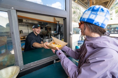 Burger being served at Snowbird's Birdfeeder on the Plaza Deck