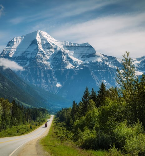 An epic shot of Yellowhead Highway leading up to snow-peaked Mount Robson.