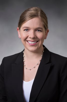 Sierra Anderson, PA-C smiling in front of a gray background.