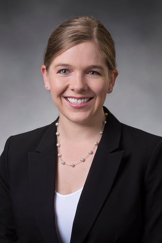 Sierra Anderson, PA-C smiling in front of a gray background.