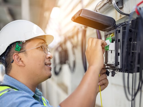 Engineer pushing buttons on control panel