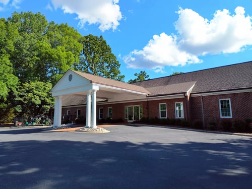 Exterior view of Novant Health Township Pediatrics, with a covered drive up area for patient drop off.