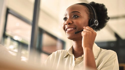 A woman is on the phone providing customer service.