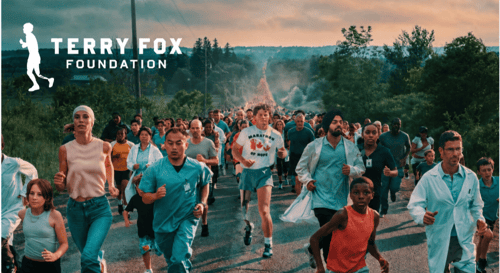 Terry fox is shown running in the middle of a road with a diverse mix of people running alongside him. The scene communicates Terry's inspiration to all Canadians. The Terry Fox Foundation Logo is shown at the top of the photo.