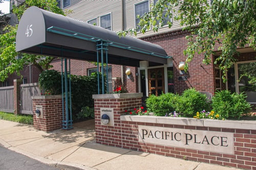 The entrance to Pacific Place, a brick building with a canopy marked 45 and a stone sign reading Pacific Place