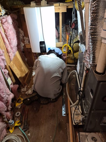 bluefrog Plumber Shae installing a wall mounted tankless water heater