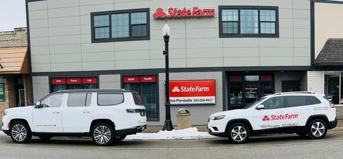 Gray and black building with red State Farm sign
