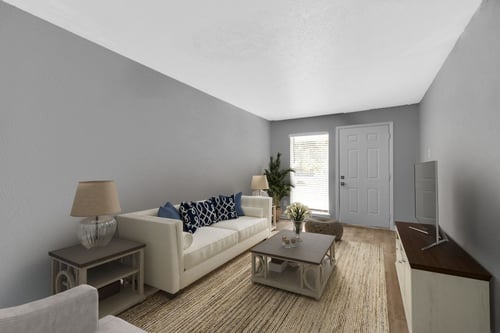 A living room with a white couch and a coffee table at 46Eleven Apartments, Dallas, 75228, Texas